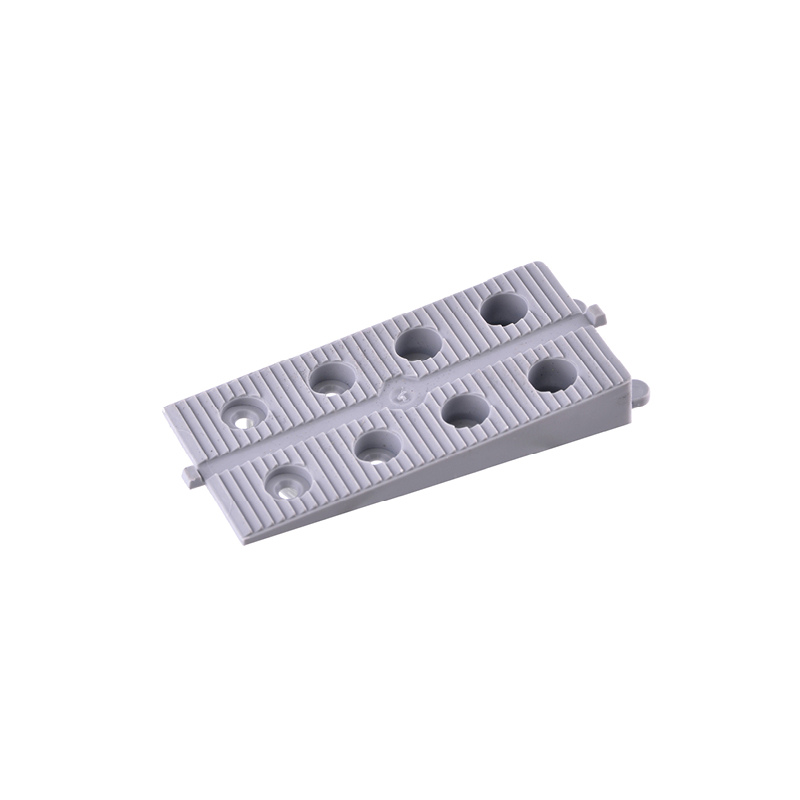 Cale grise percée pour ajustement.