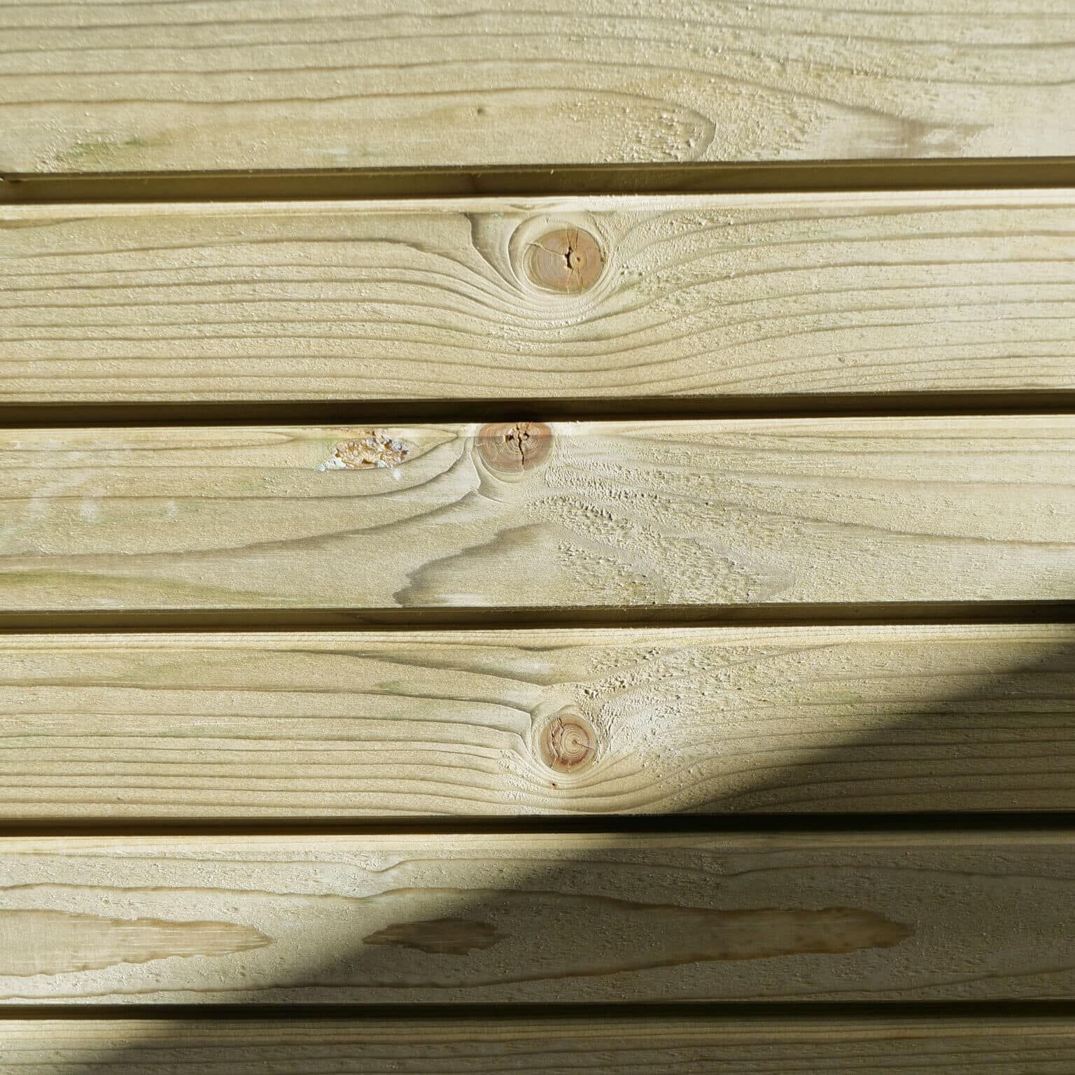 Plancher en bois naturel avec nœuds visibles.
