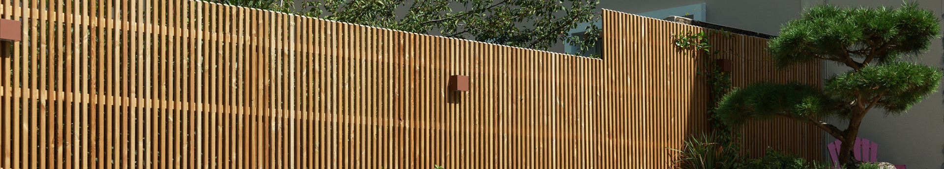 Clôture en bois avec arbre à côté.