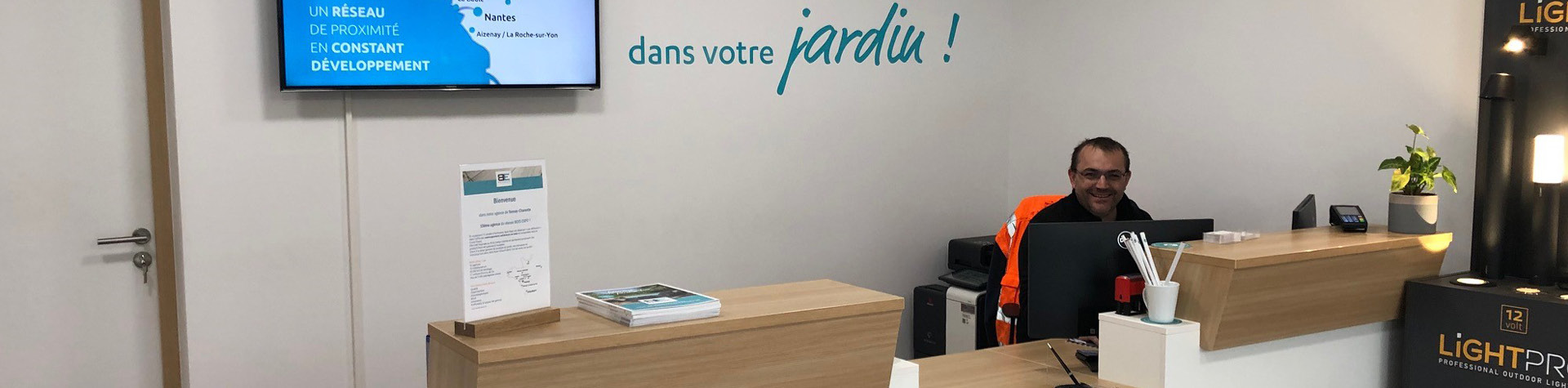 Accueil entreprise, homme souriant au bureau.